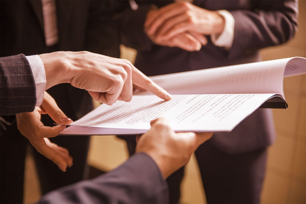 cropped view of businesswomen reading document